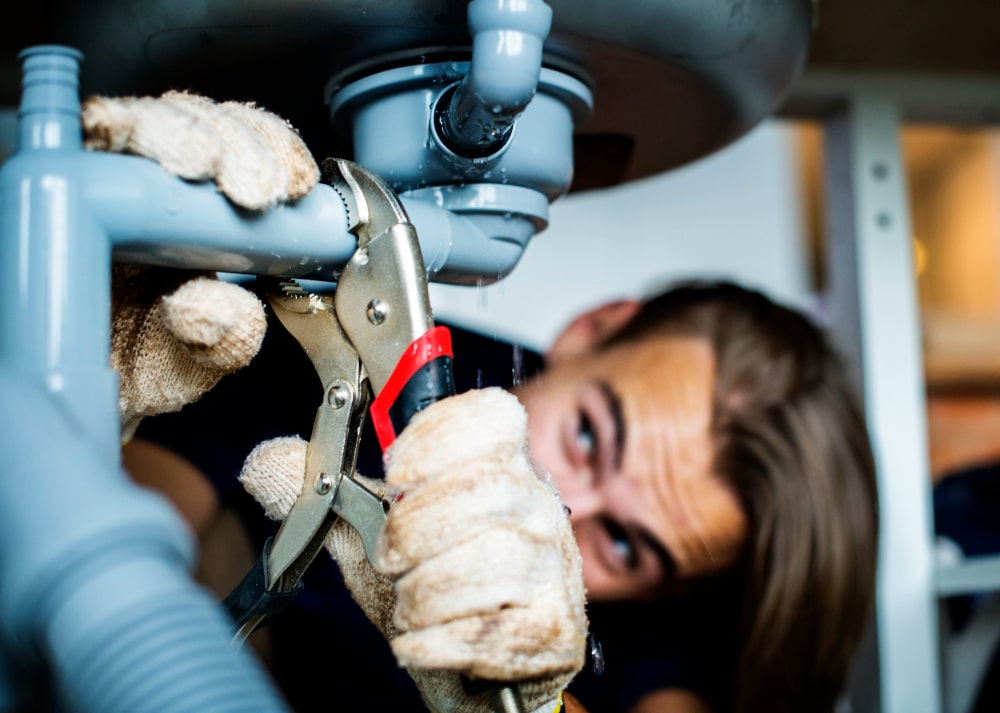 Plumber fixing kitchen sink faucet in Pickering